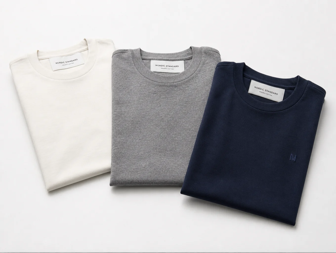 Custom branded cotton t-shirts displayed on studio flat-lay